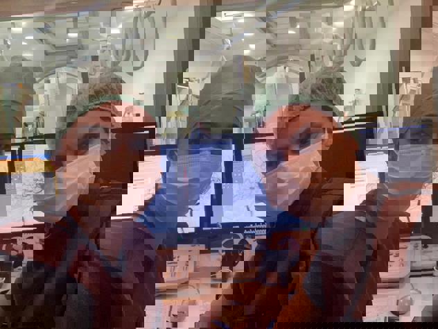 Dr. Senadim Songul, Interventional Neurologist, and colleague looking at scans in the interventional suite